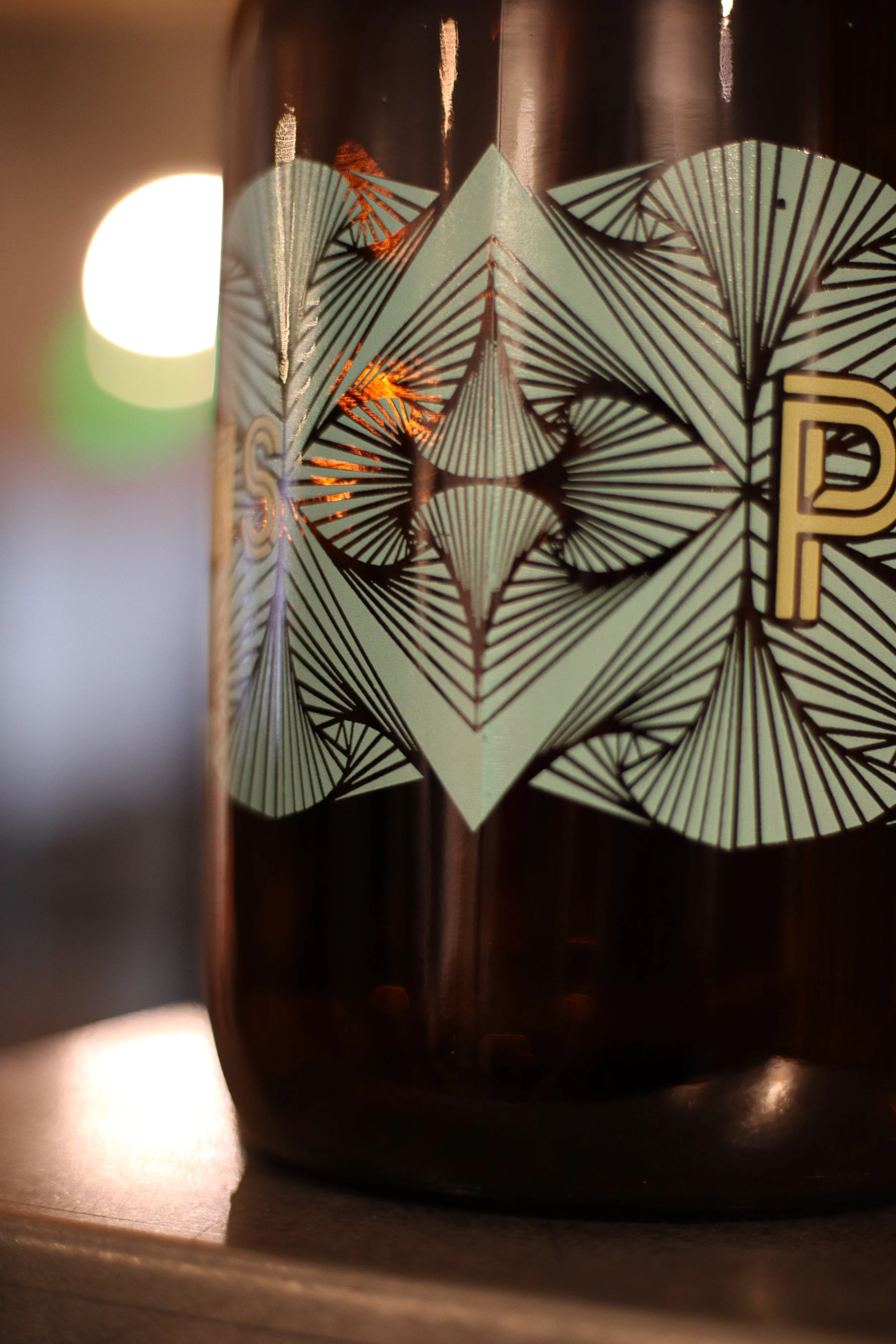 Custom screen printed growler with geometric label design, produced by MOAB for breweries and beverage branding in Texas.