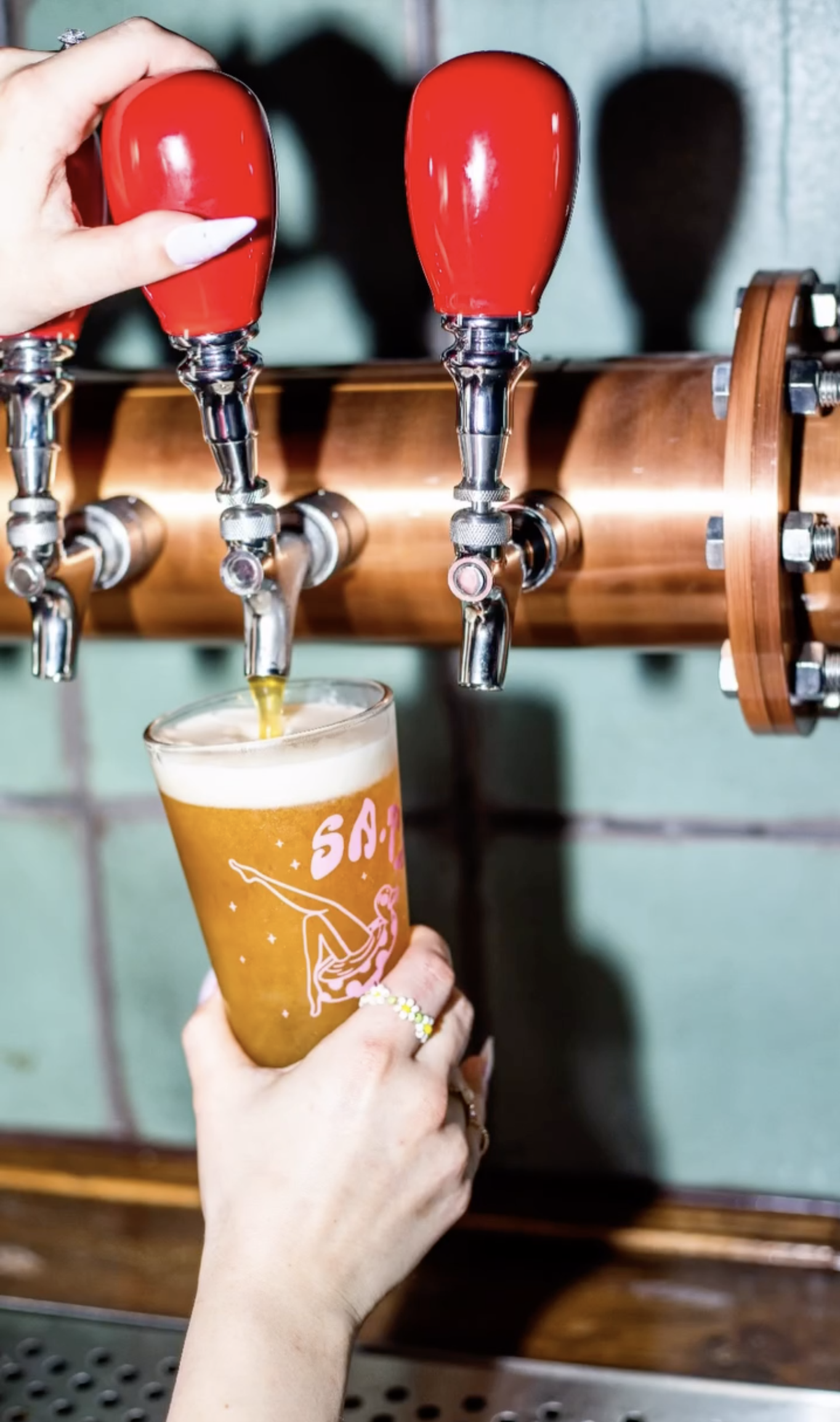 Custom-branded brown glass beer bottle with ‘El Paso Wing Factory’ logo, screen printed by MOAB for restaurant branding in Texas.

