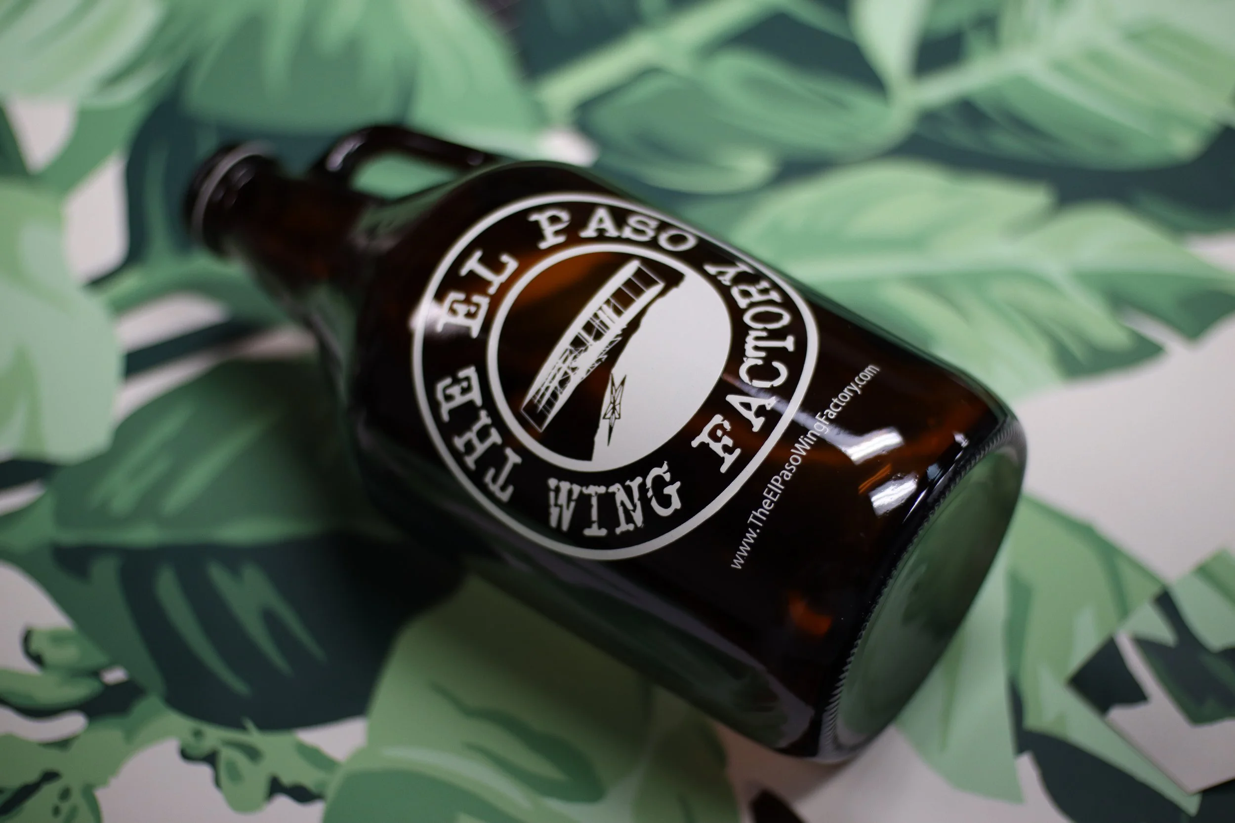 Screen printed growler featuring 'The El Paso Wing Factory' logo, custom-printed by MOAB for restaurant and brewery promotions in Texas.