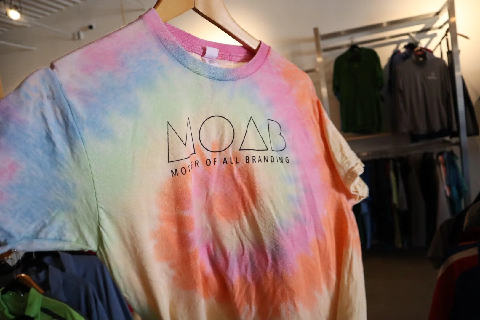 Custom tie-dye t-shirt with "MOAB" branding, screen printed by MOAB for stylish and promotional apparel in El Paso, TX.