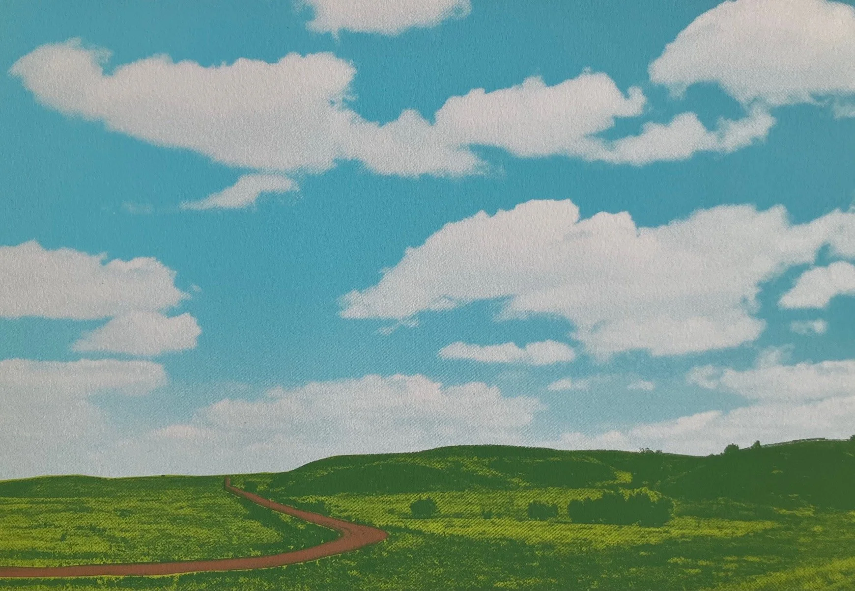 Green landscape with blue sky and clouds