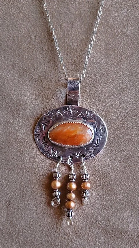 Silver pendant with orange stone