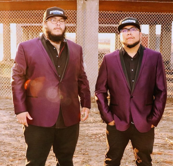 men with beards in matching maroon jackets
