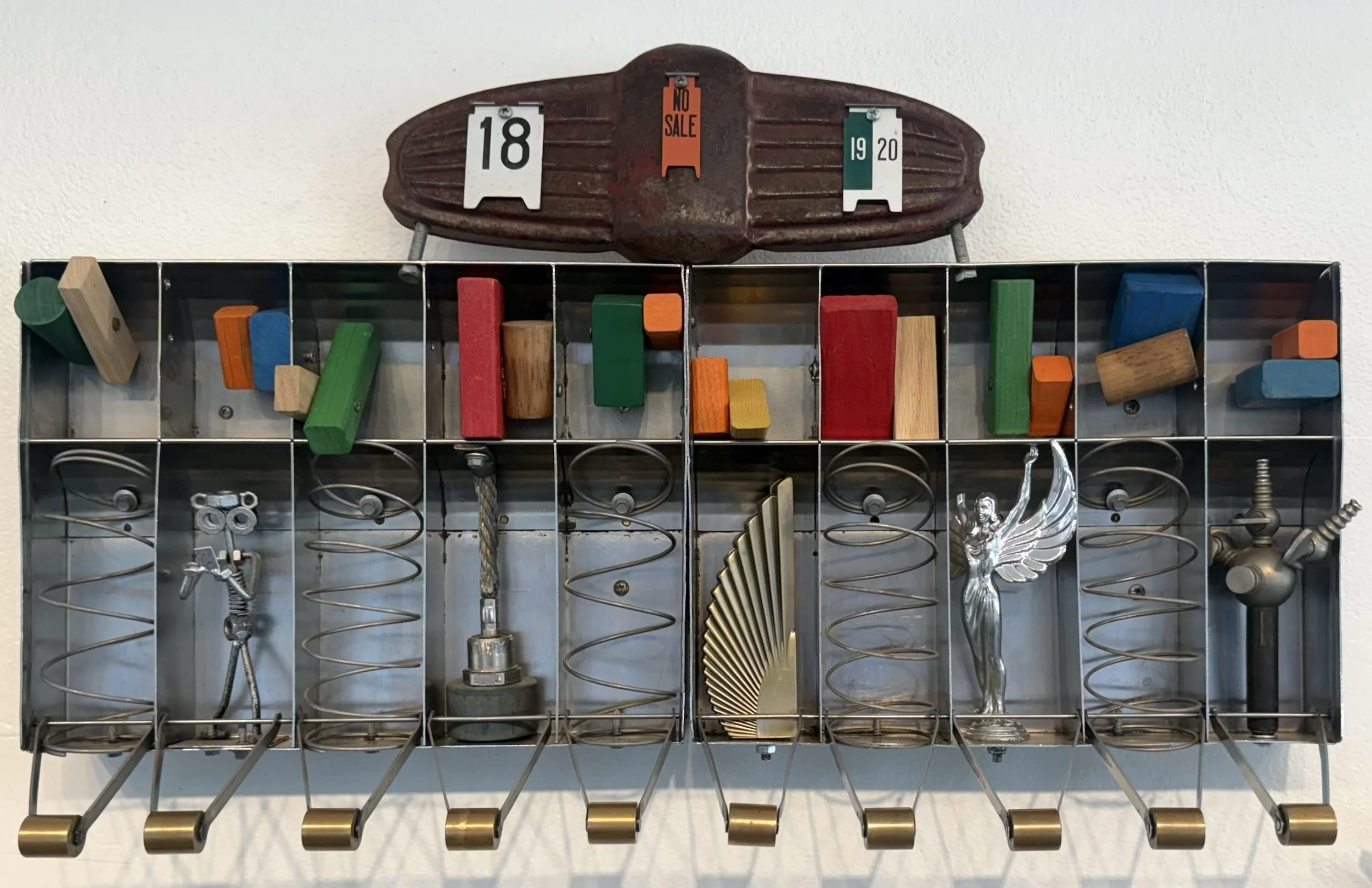 Artwork with metal star, curving pipe and gears