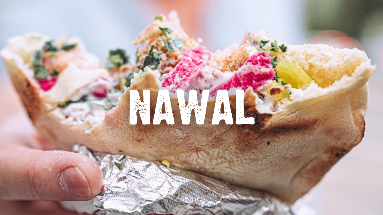 Nawal with a hand holding a falafel pita sandwich