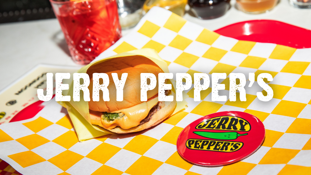 Jerry Pepper's with a smash burger on checkered paper and drink in the background