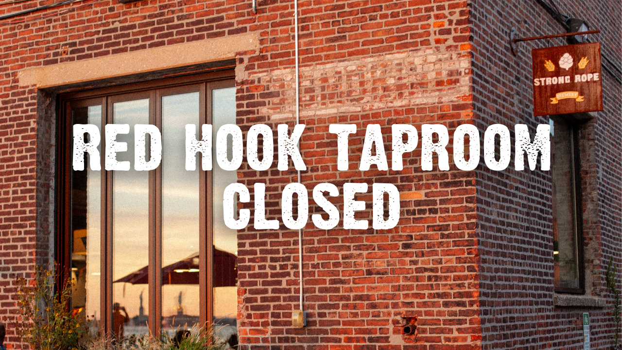 Red Hook Taproom Closed with brick facade and a reflection of the water and Statue of Liberty with a small tin Strong Rope hanging sign