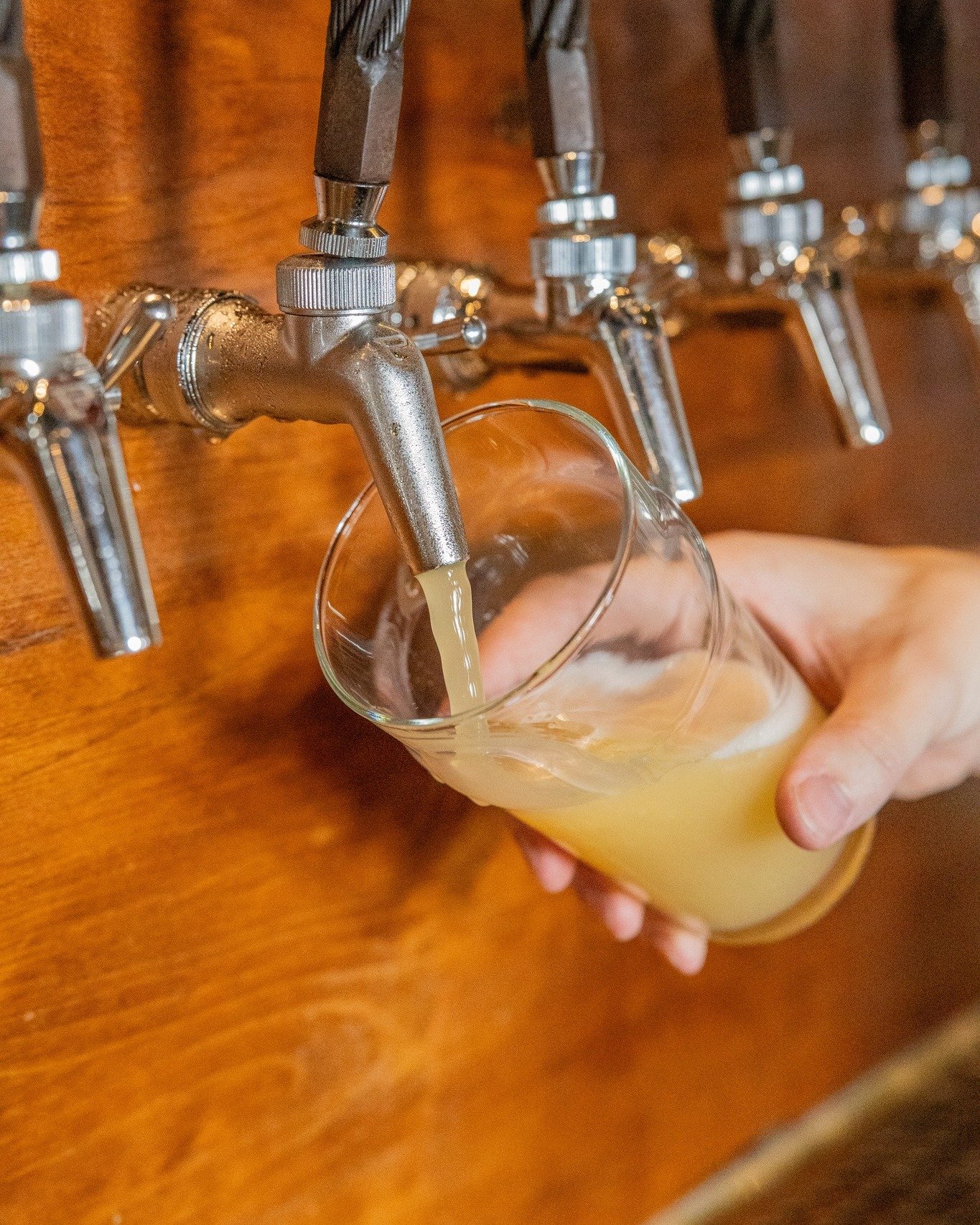 Beer being poured from a tap into a pint glass