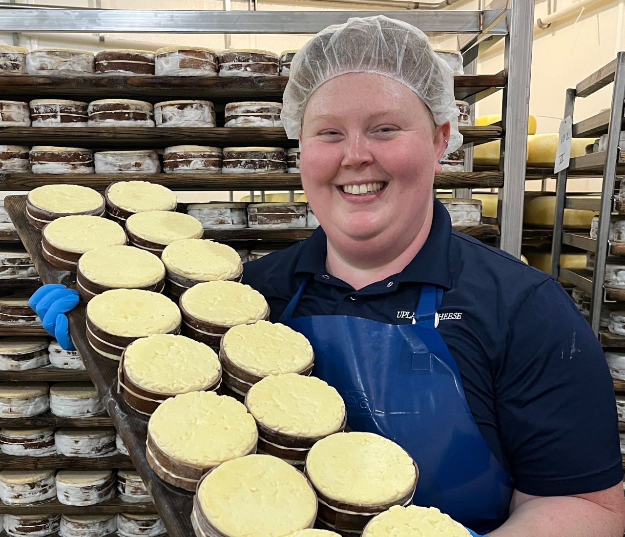 Hanna Lee poses with a tray of cheeses
