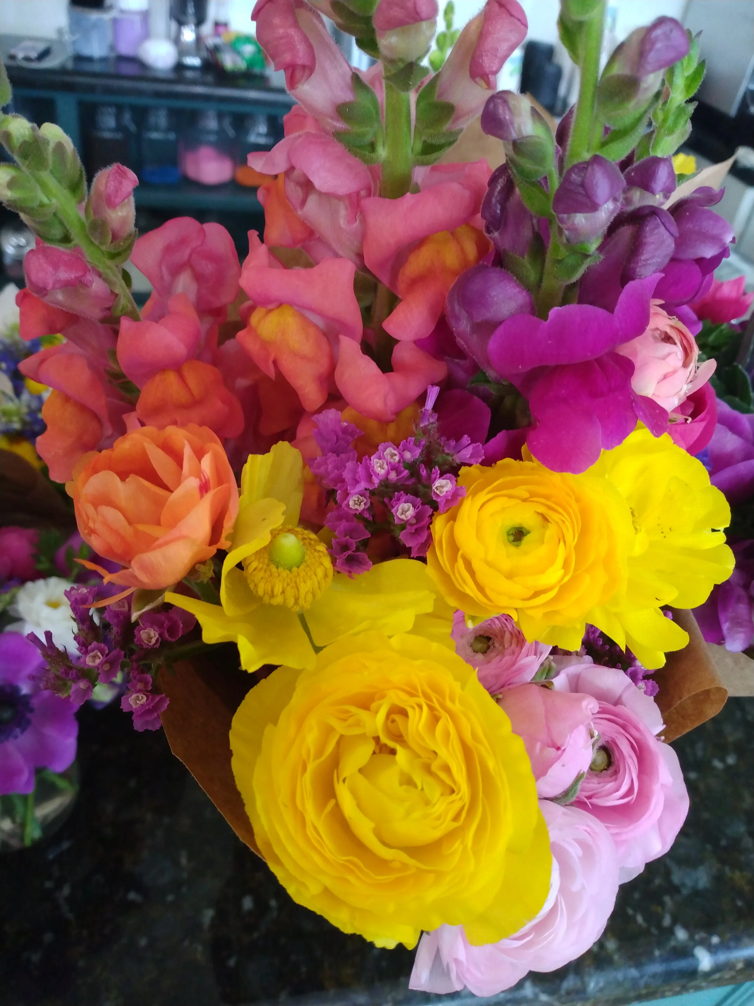 Warm color bouquet with ranunculus and snapdragons