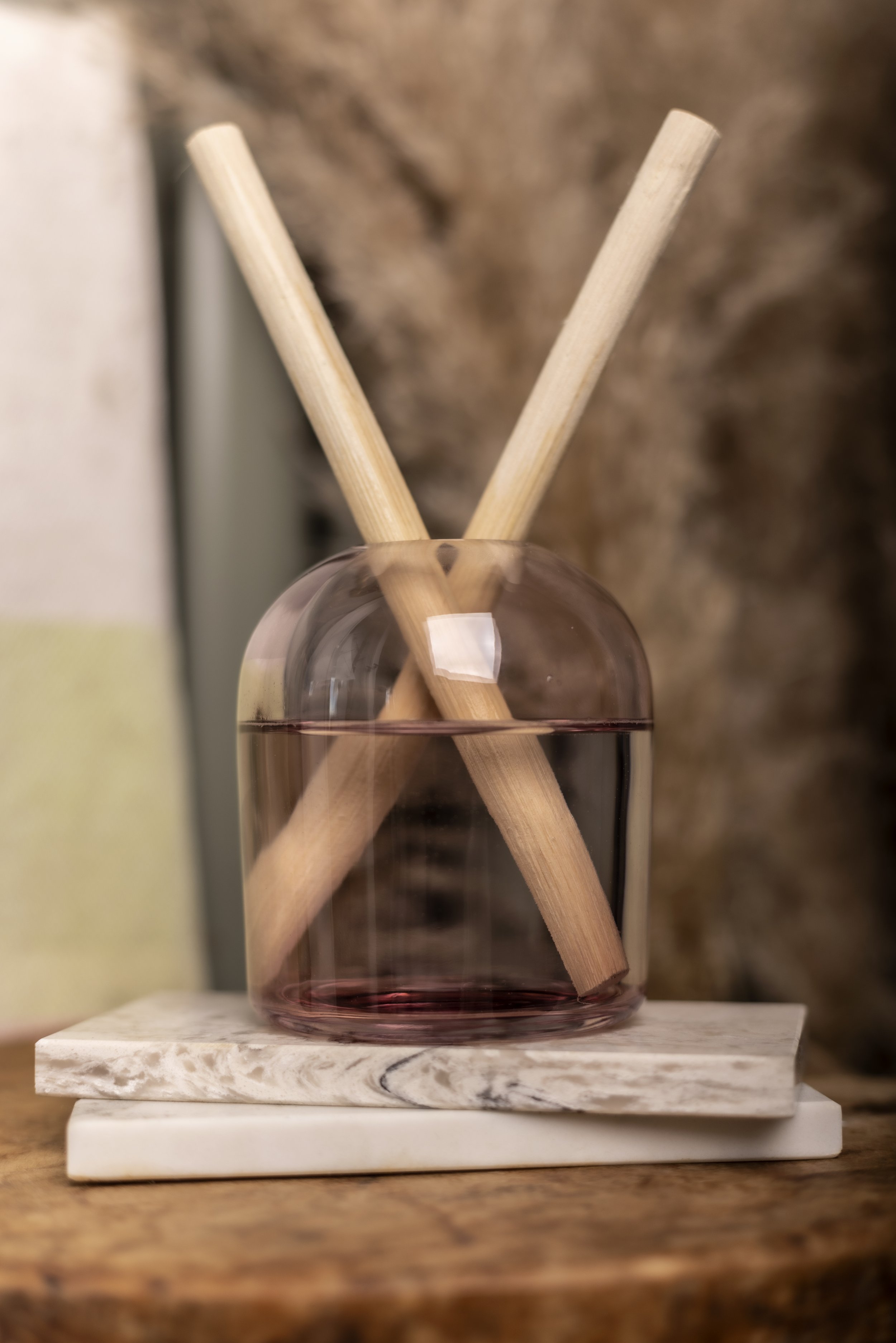 Reed diffuser on marble and wood surface