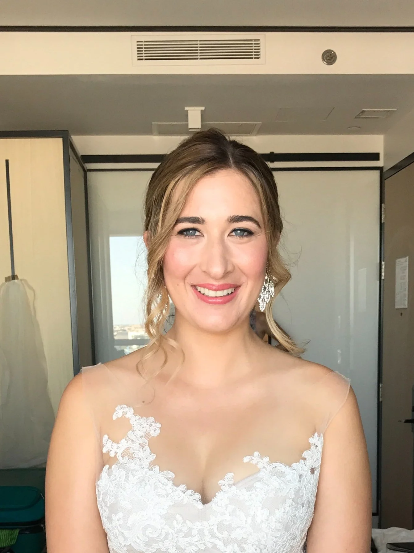 romantic updo with face framing pieces for a wedding