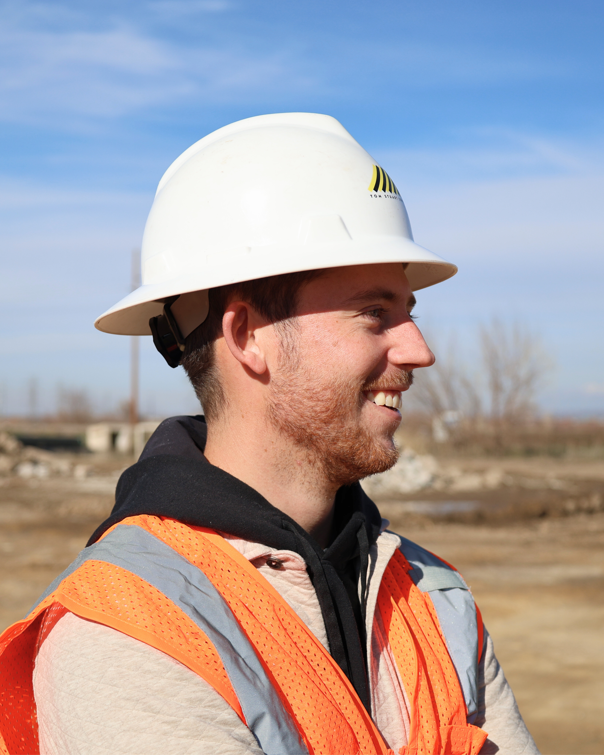 Ryan Stuart, Tom Stuart Construction. Smiling at a jobsite.