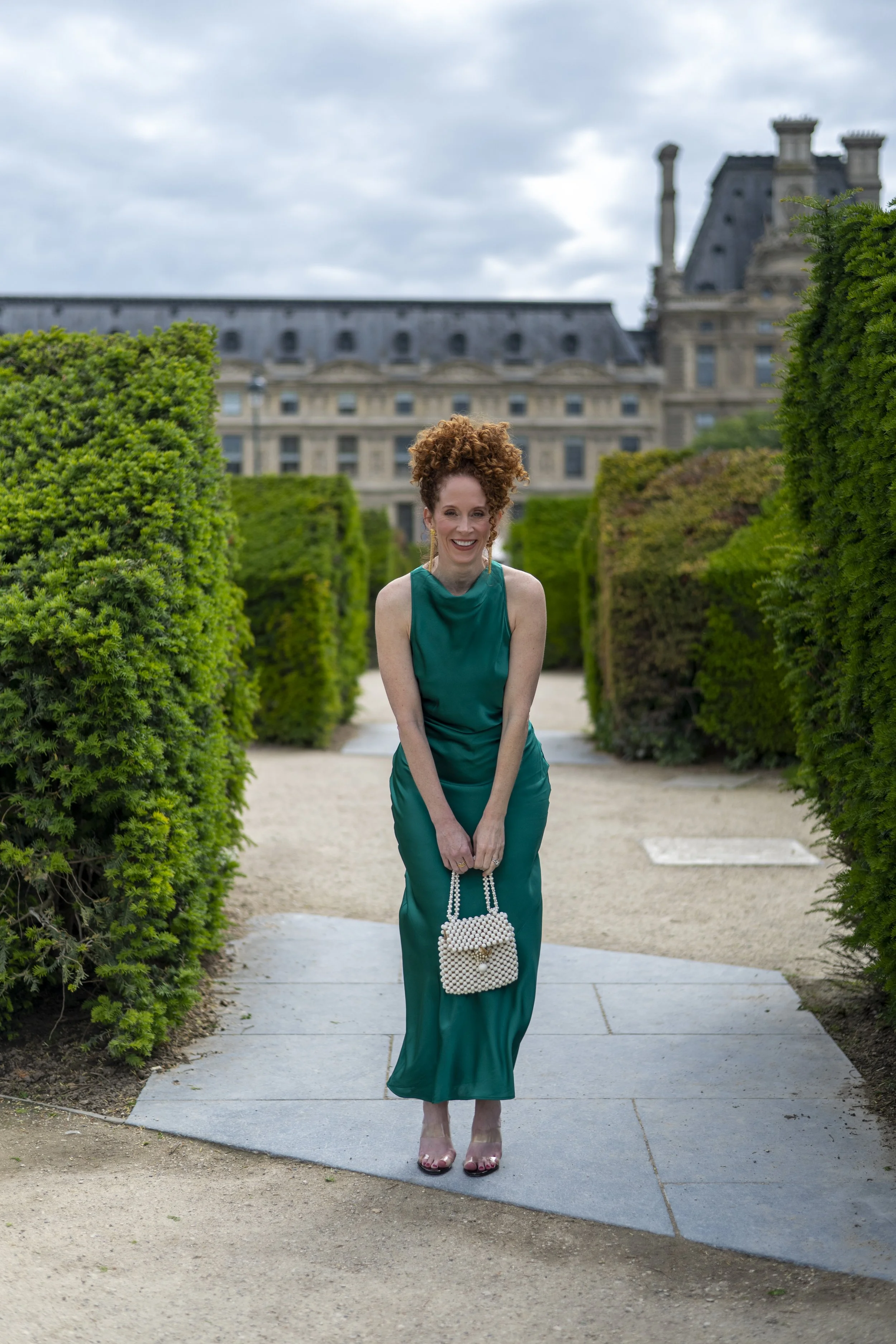 Dr. Kristin Markell, double board-certified OB/GYN and perimenopause coach smiling in Paris.