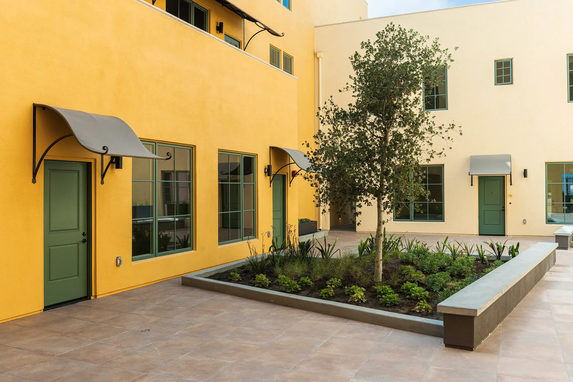 exterior real estate photography of a landscaped courtyard at walnut crossing pasadena by uptick strategic advisors