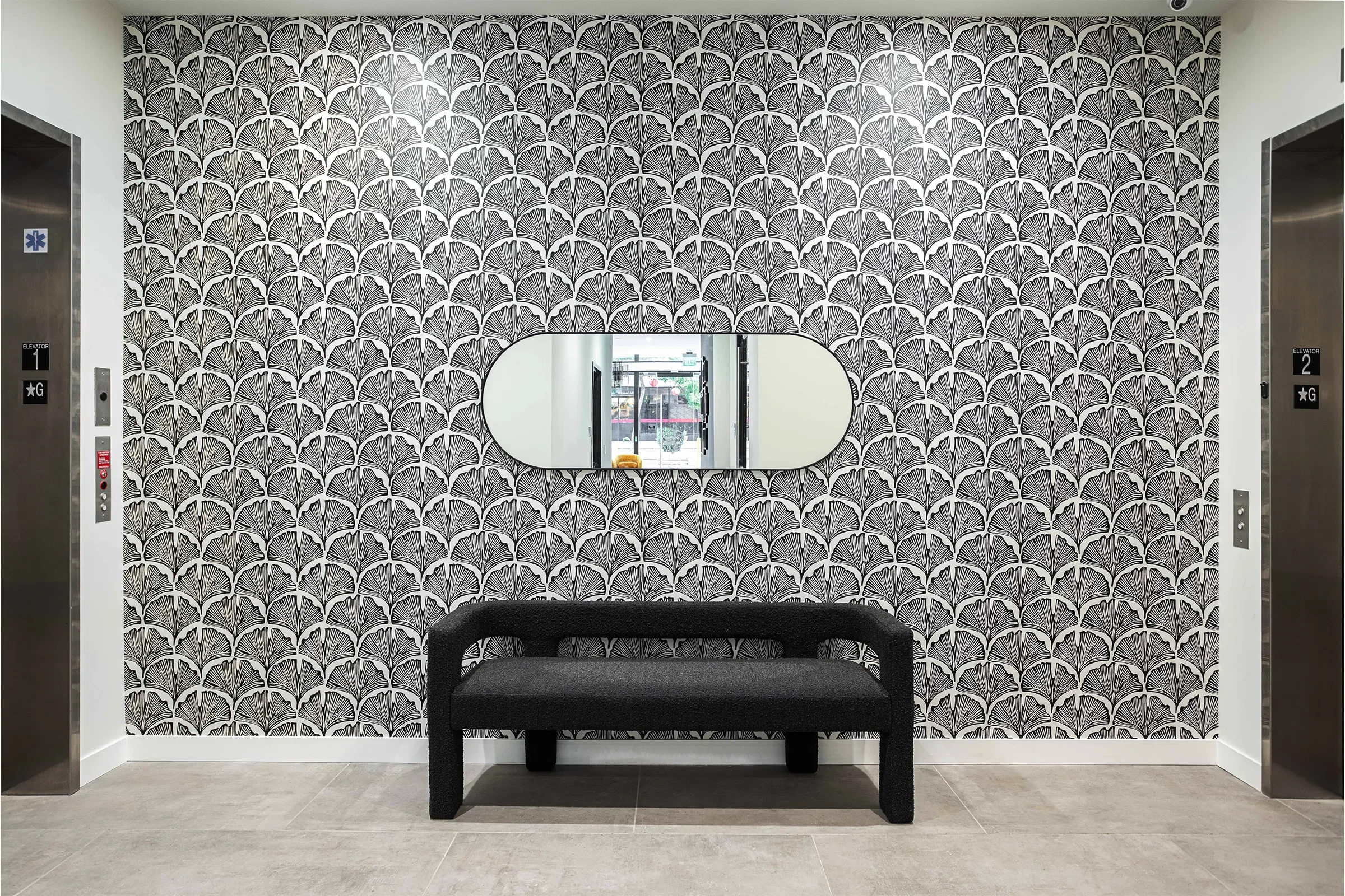 hiro house main lobby showcasing modern residential design with patterned wallpaper, sculptural bench seating, and refined interior details in little tokyo, los angeles