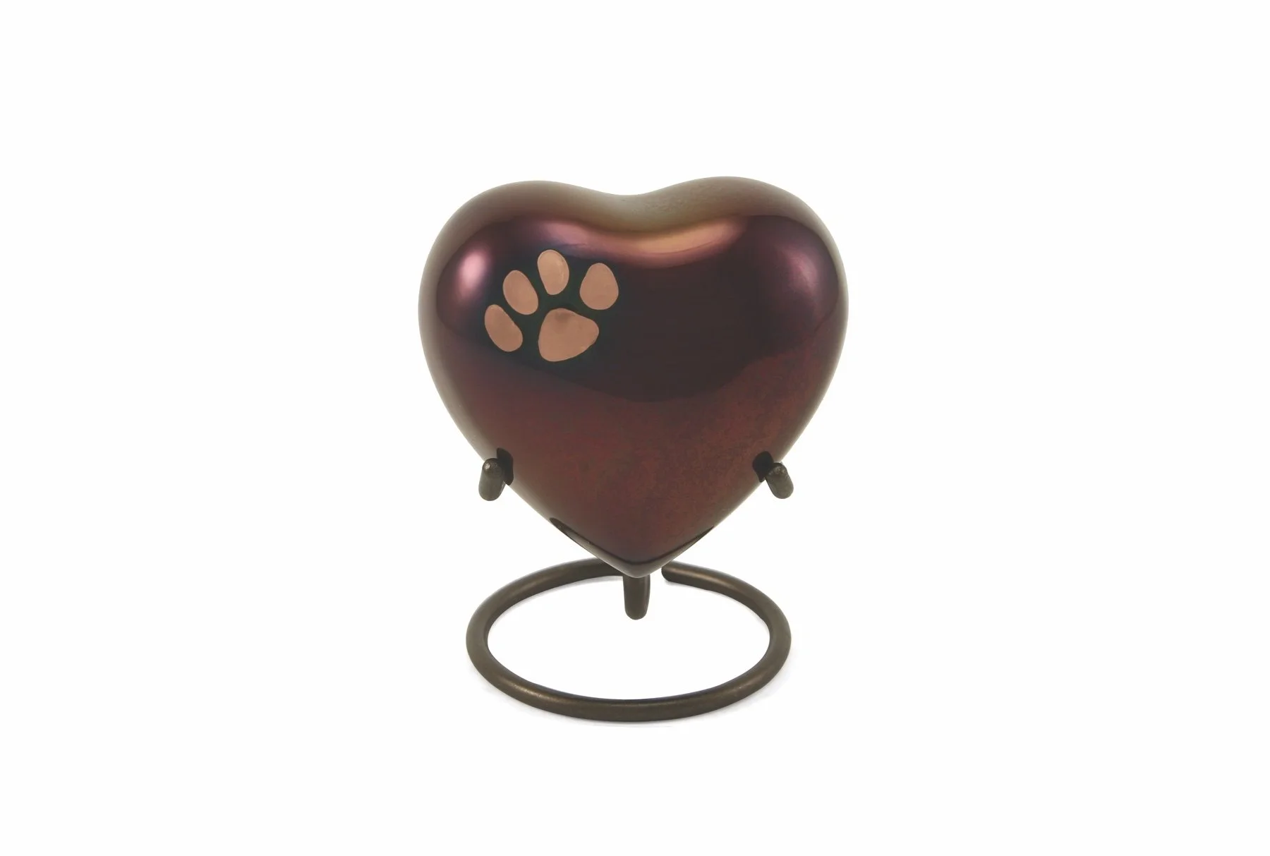 Raku-finished heart shaped brass pet urn with pewter paw prints, handcrafted and available with optional engraving.