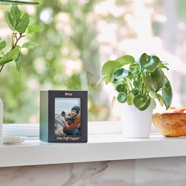 Black photo urn with a photo slot for pets, customizable with engraving, from Faithful Companions.