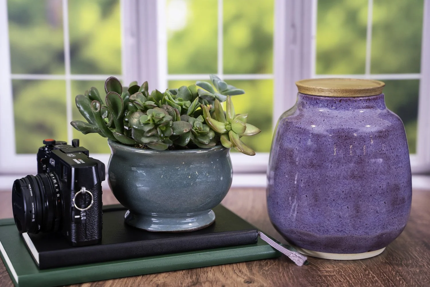 Handmade ceramic pet urn with iris purple glaze and solid acacia wood lid, suitable for engraving.