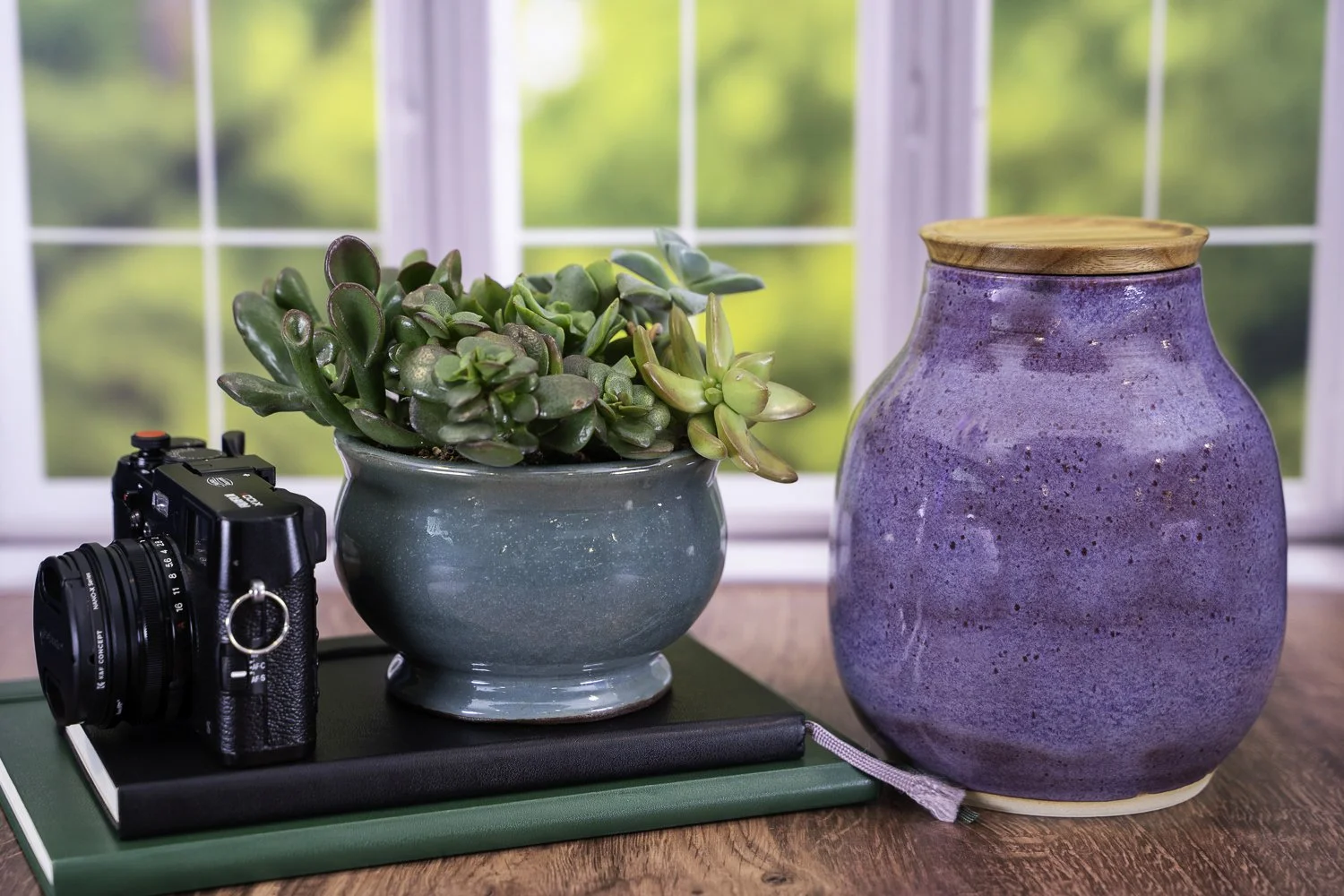 Handmade ceramic pet urn in iris purple glaze with solid acacia wood lid, suitable for engraving.