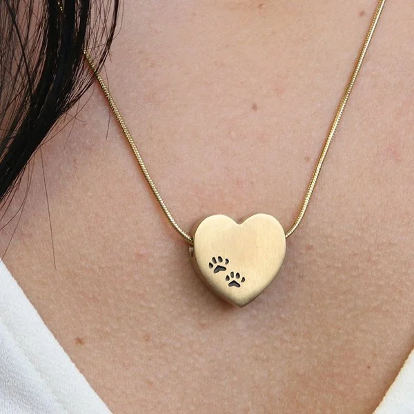 Bronze heart-shaped pendant with black paw prints, matching 19-inch chain, and discreet memento compartment.