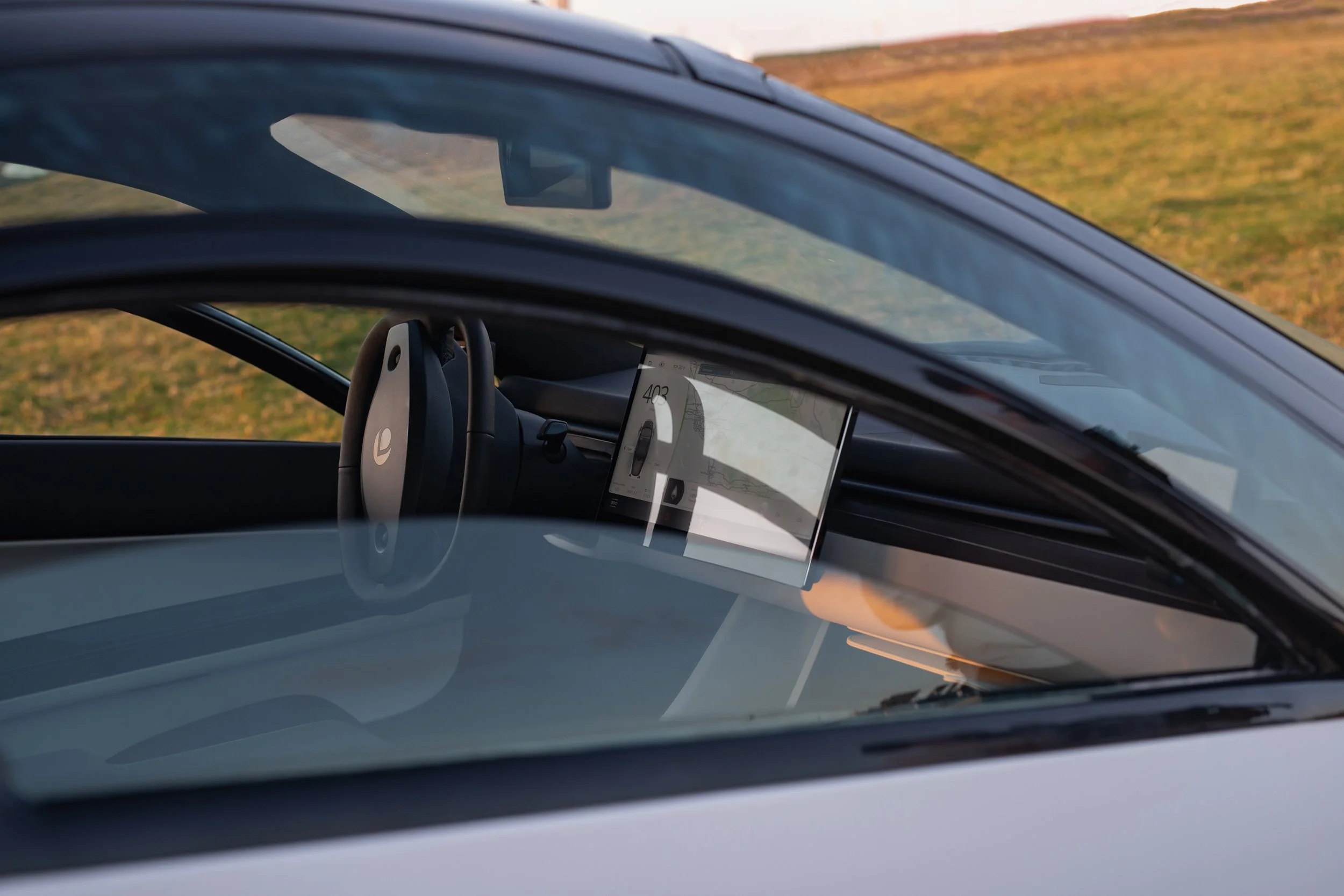 Lifestyle closeup of the unique Aptera steering wheel and column