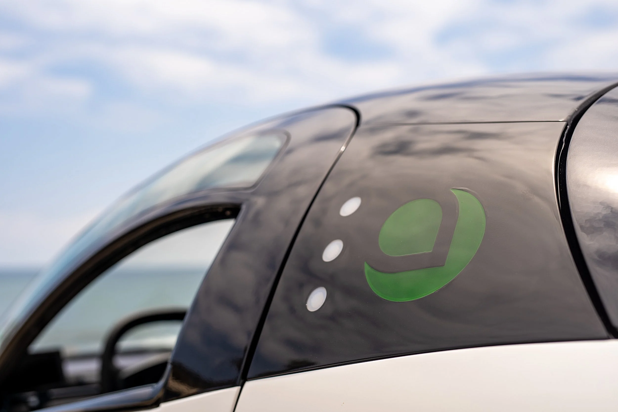 Close up feature image of the Aptera logo on the vehicle