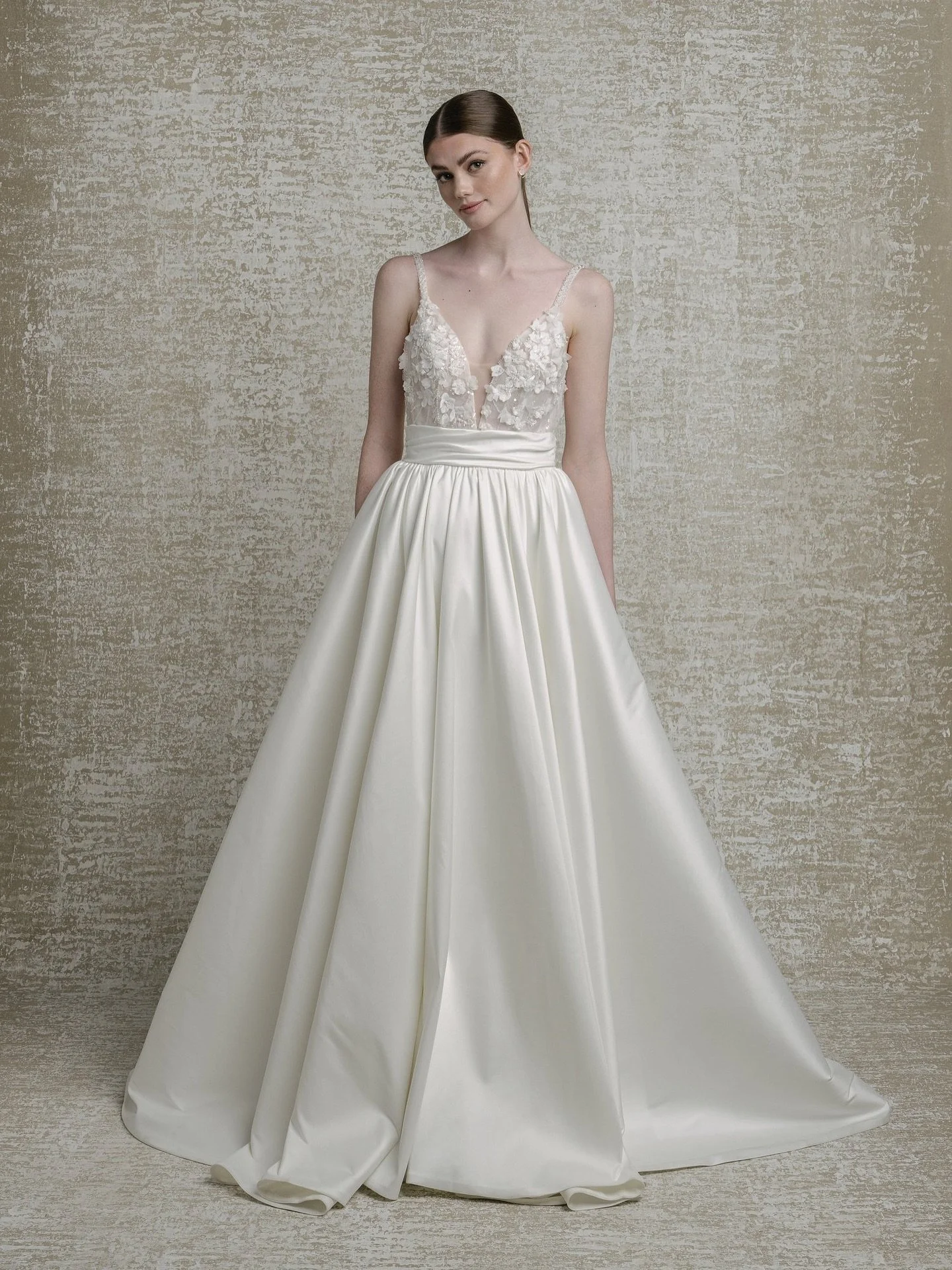 She&rsquo;s bold, romantic, and effortlessly elevated.
Meet Renee, by Lis Simon, featuring beaded 3D floral lace, a deep V, a low back, and a full mikado A-line skirt that delivers that signature Gamby-Girl glow.

Aisle-ready glamour starts here.

Bo