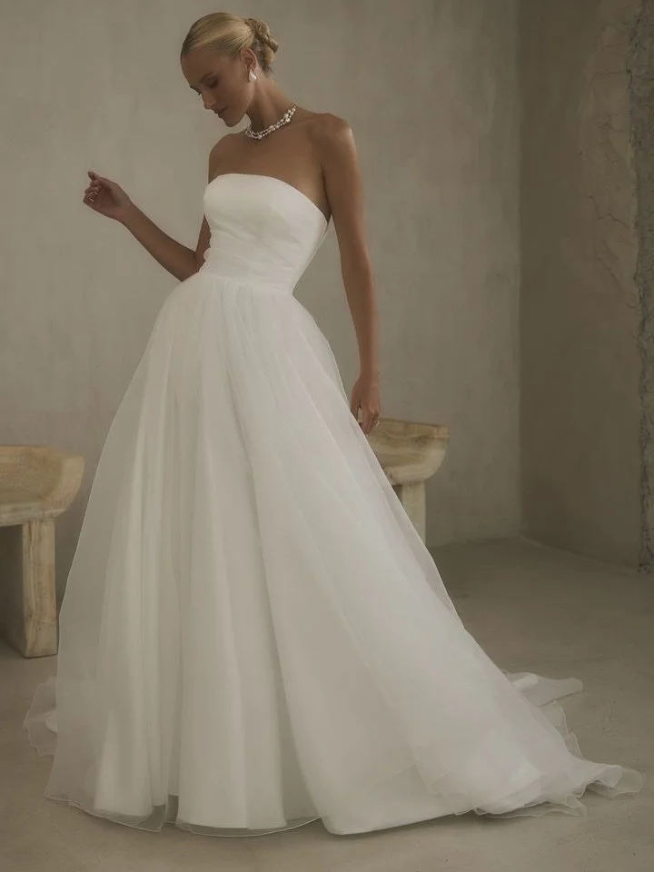 Stop scrolling, this one just arrived ✨

Introducing Charisse by Casablanca Bridal, our newest arrival at Gamberdella. Clean lines, a sculpted pleated bodice, and a straight-across neckline set the tone, while layers of airy crepe organza cascade int