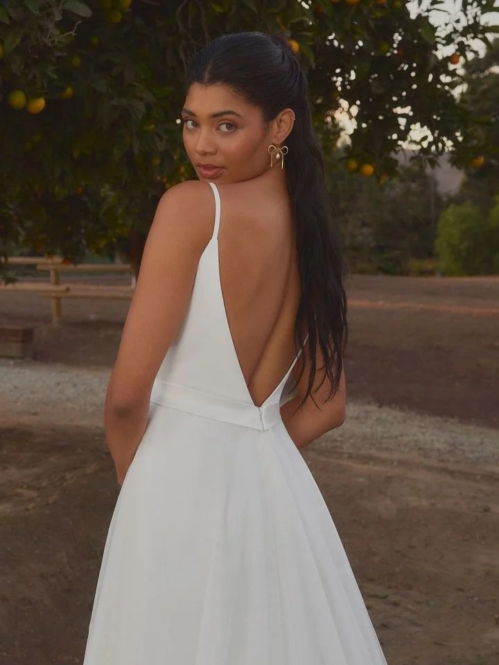 Coming soon to Gamberdella ✨

Cori by Beloved by Casablanca makes her statement from behind. Delicate spaghetti straps frame a striking deep V-back, perfectly mirroring the neckline in front. Finished with a twirl-worthy tulle skirt, she&rsquo;s eleg