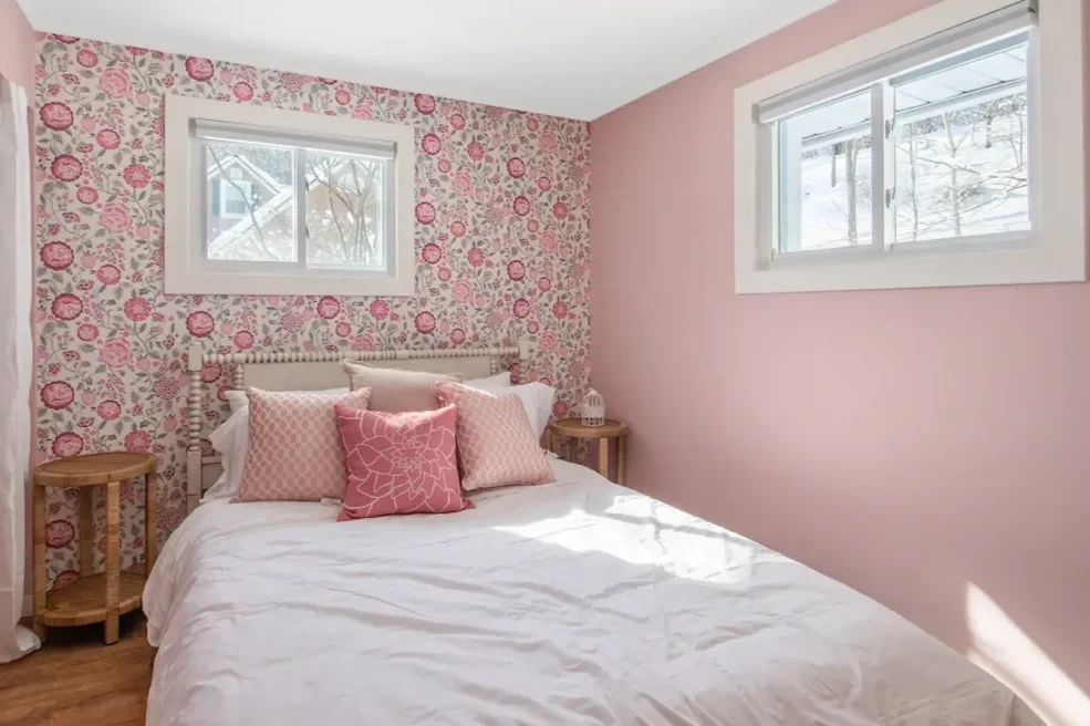 Wildflower Cottage short-term rental design pink bedroom with floral wallpaper view