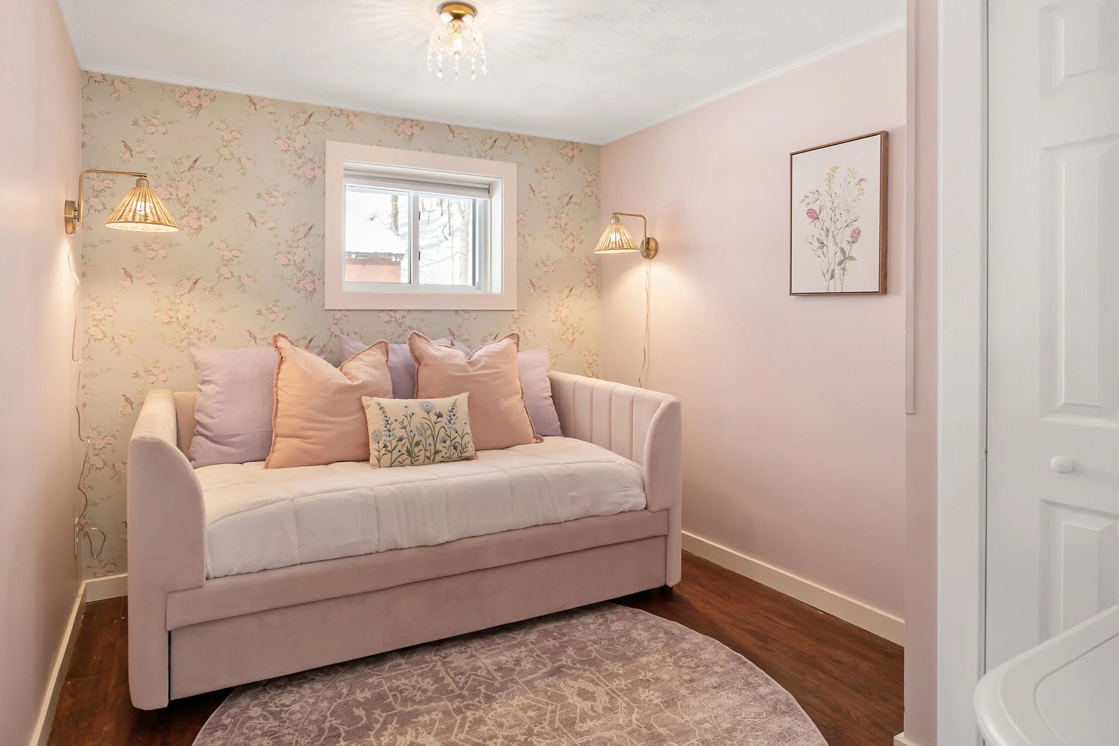 Themed Airbnb Wildflower Cottage short-term rental design soft pink floral bedroom with daybed and pastel accents.