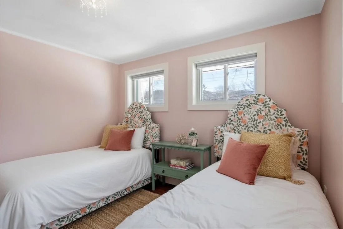 Wildflower Cottage short-term rental design pink twin beds bedroom with floral decor.