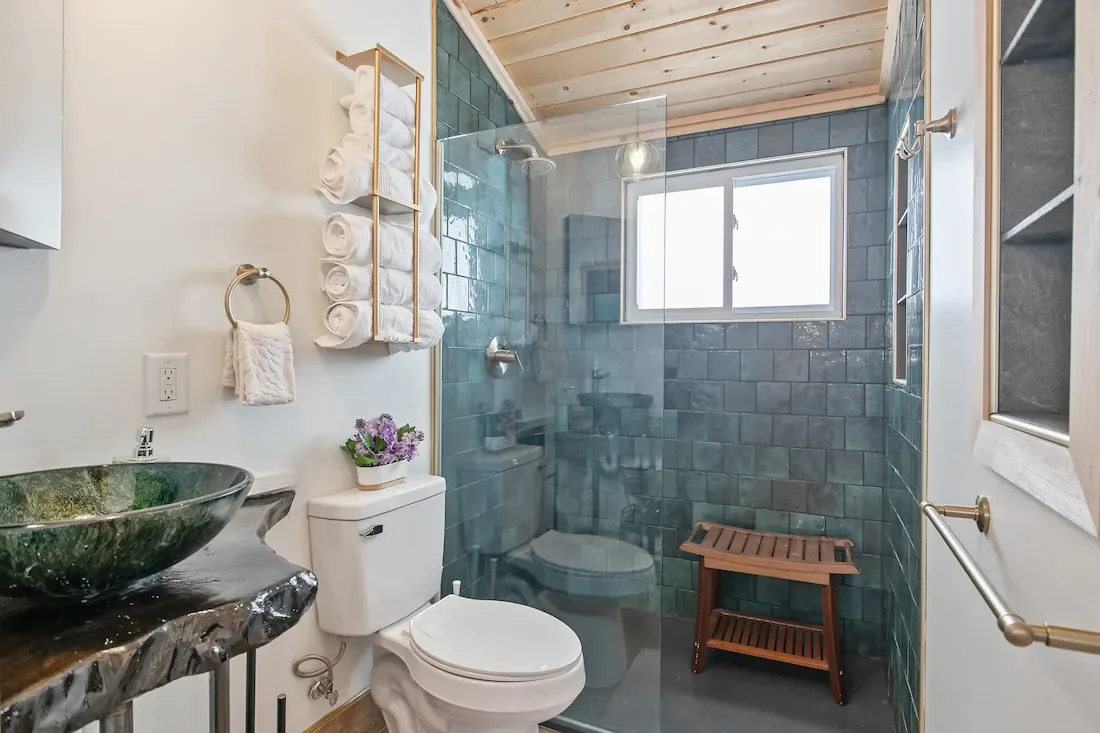 Wildflower Cottage short-term rental design natural wood and stone bathroom view