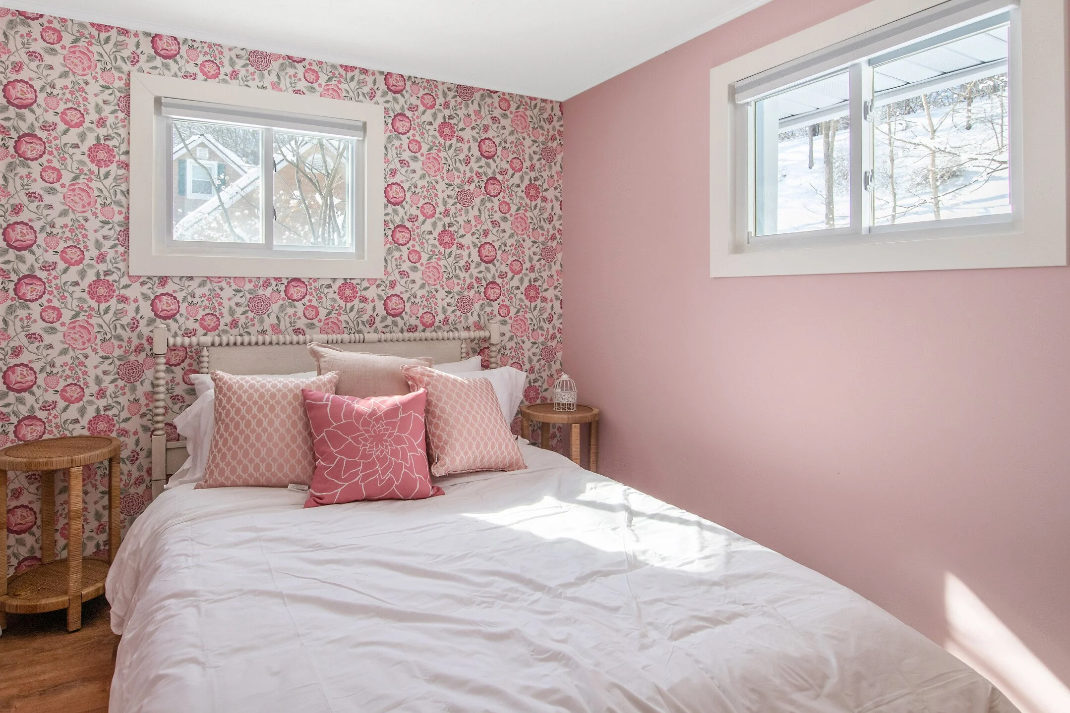Themed Airbnb Wildflower Cottage short-term rental design pink floral wallpaper bedroom.