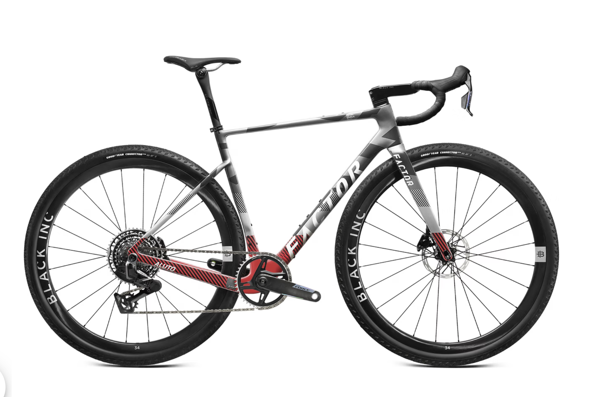 Ein modernes Rennrad mit schwarzem, weißem und rotem Rahmen, großen Reifen, flachem Lenker und scharfen Designakzenten.