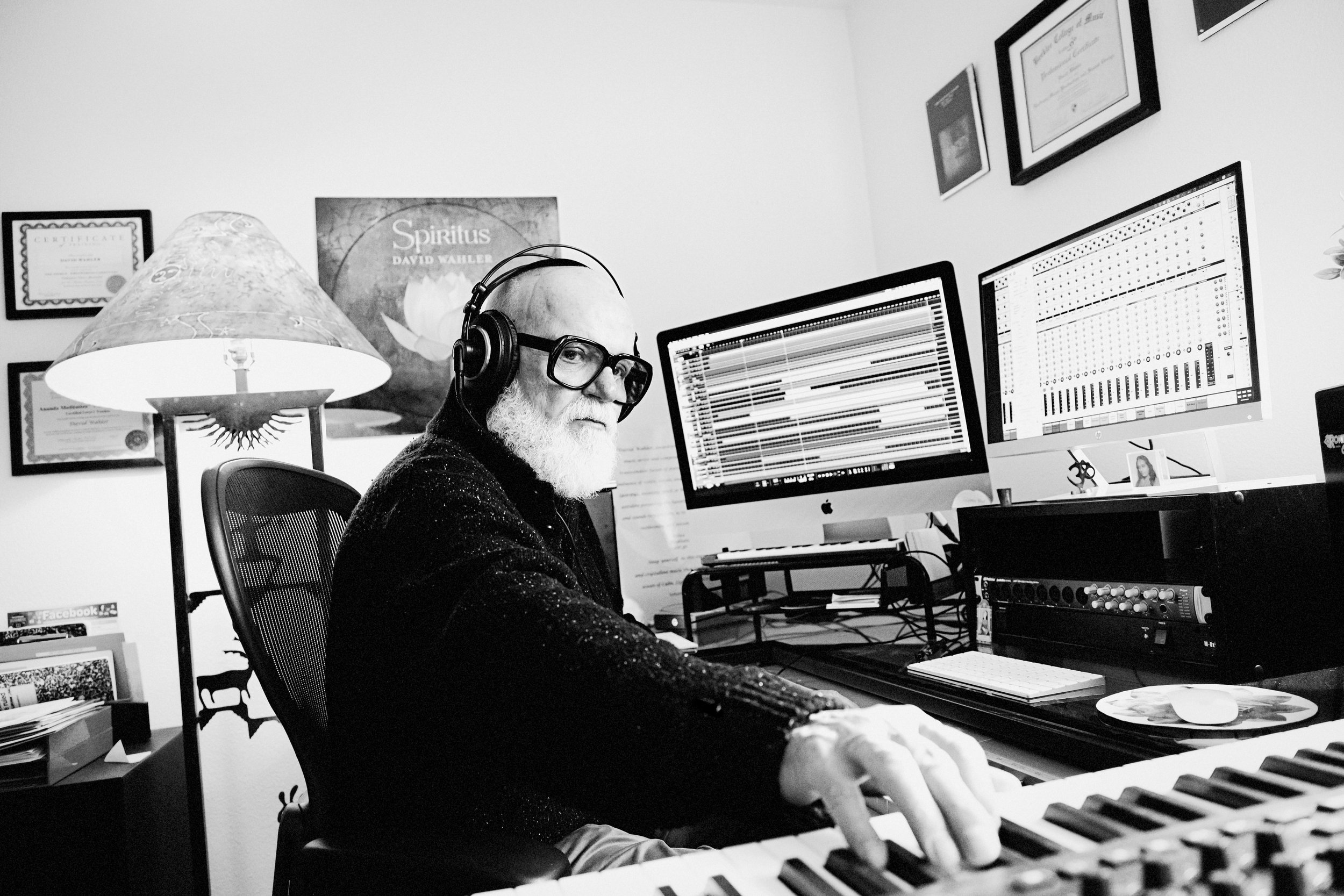 Older man working in studio musician sound keyboard black and white lifestyle marketing image