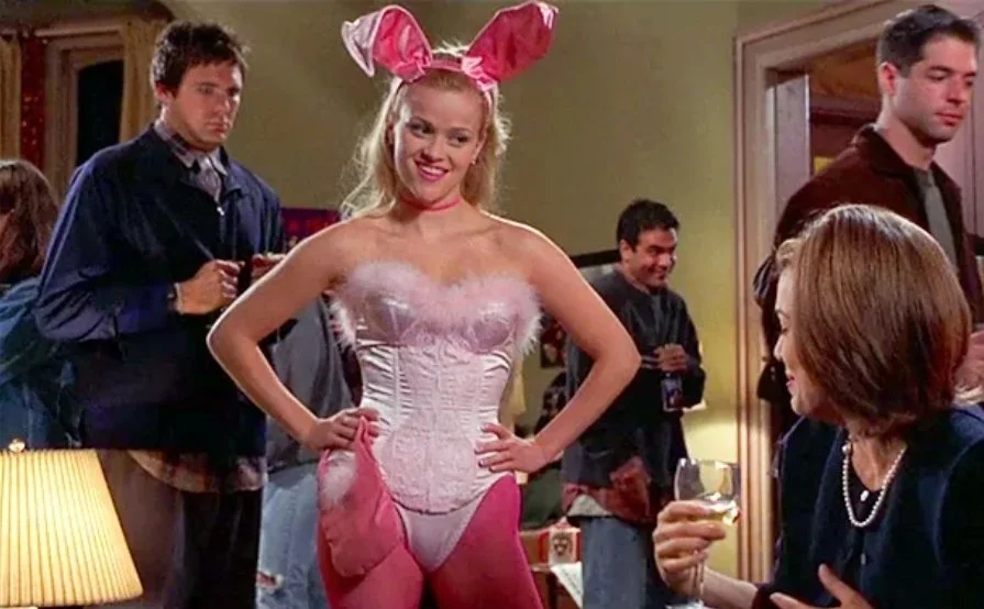 Scene from the movie "Legally Blonde" of character Elle Woods at a party dressed as a bunny with her hands on her hips.