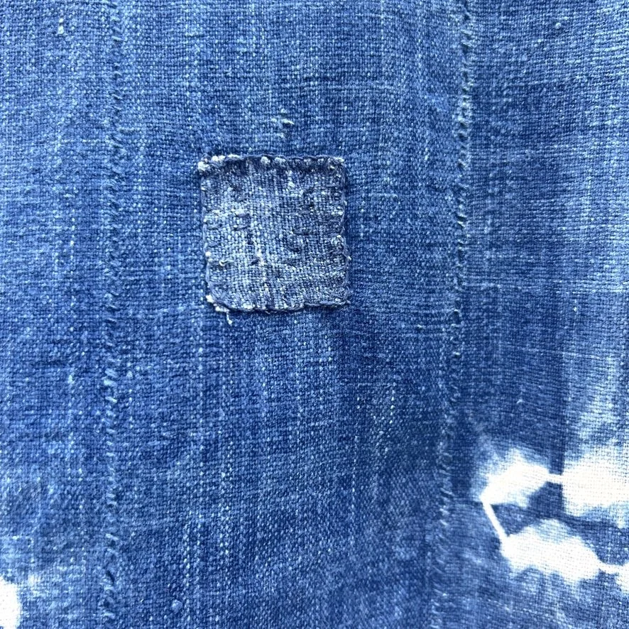 large indigo textile resist-dye with fringe closeup patch