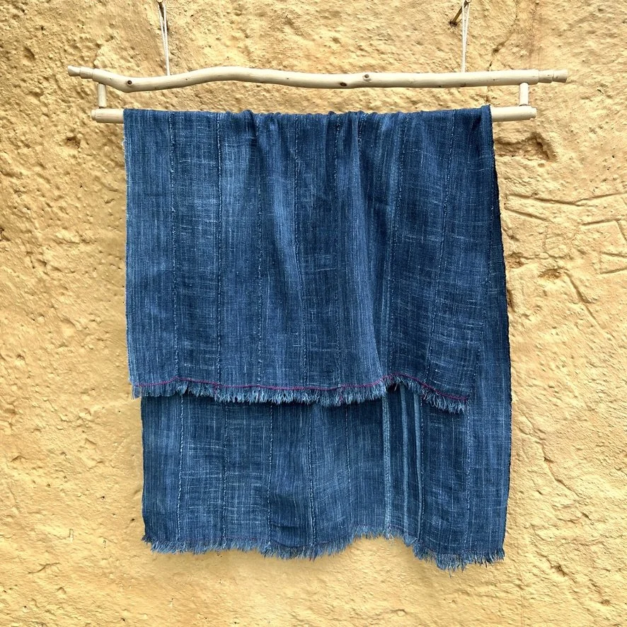 vintage indigo cloth Mali with hand-stitched detail yellow wall