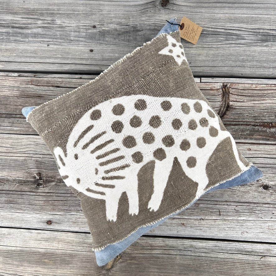 Mali mud cloth hyena cushion cover on wood