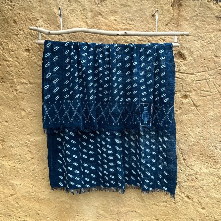 Indigo cowrie shell visibly mended on yellow background