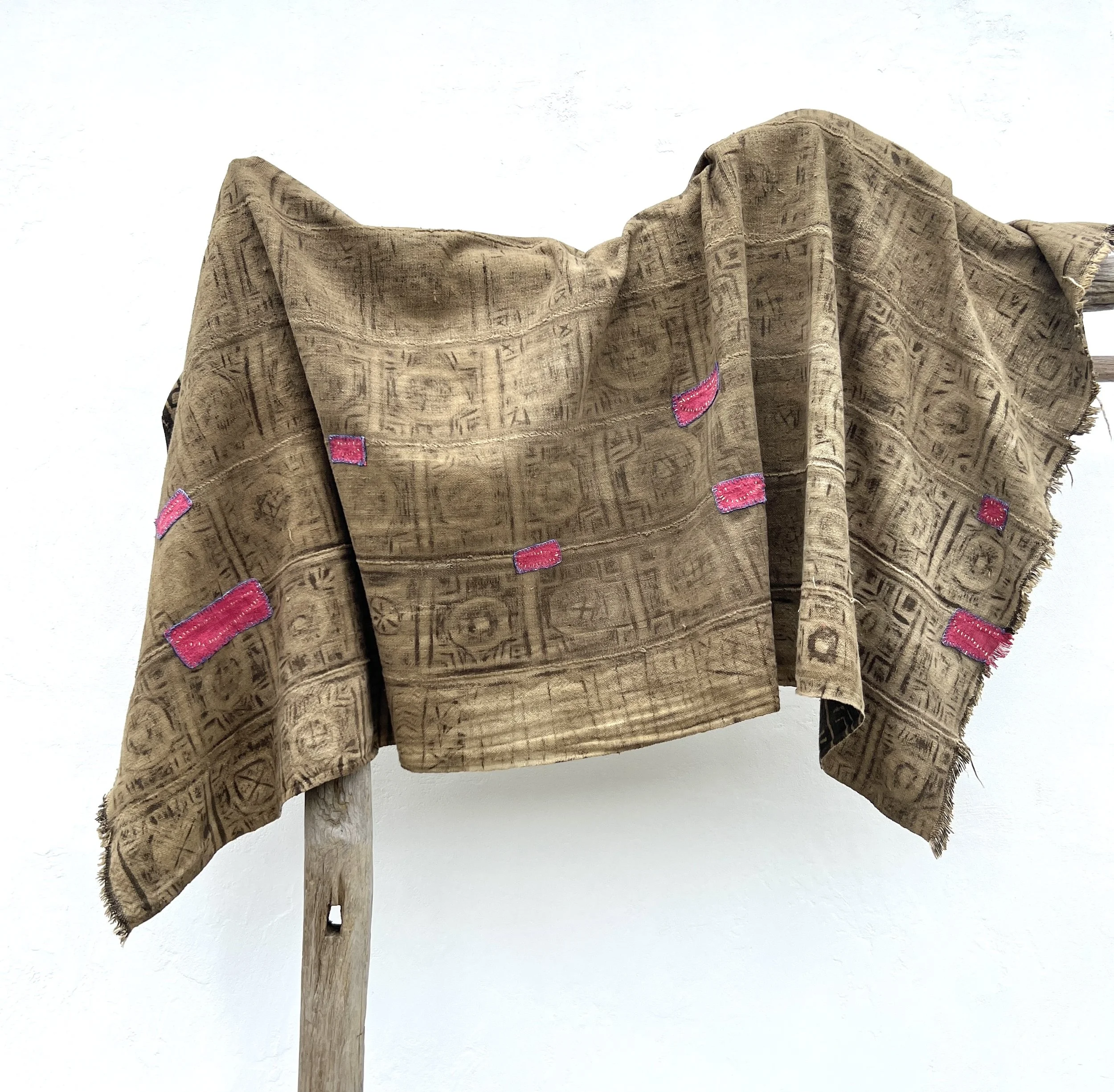 Visibly mended Mali mud cloth hanging reverse