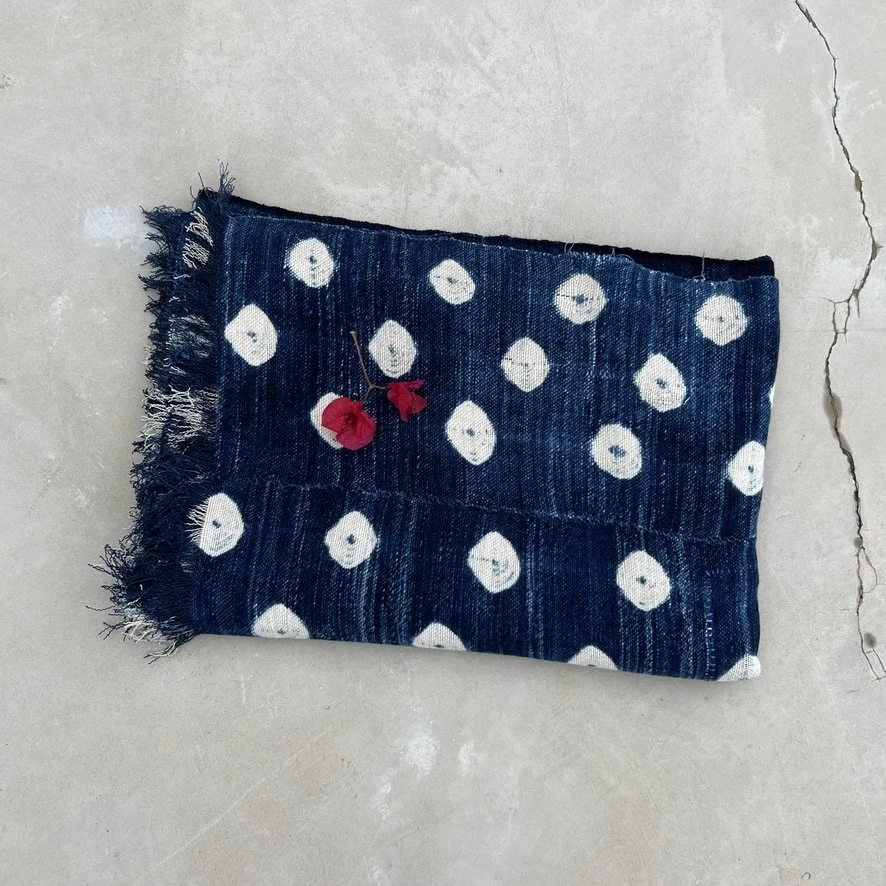 Indigo cloth dark blue cowrie shells visibly mended folded