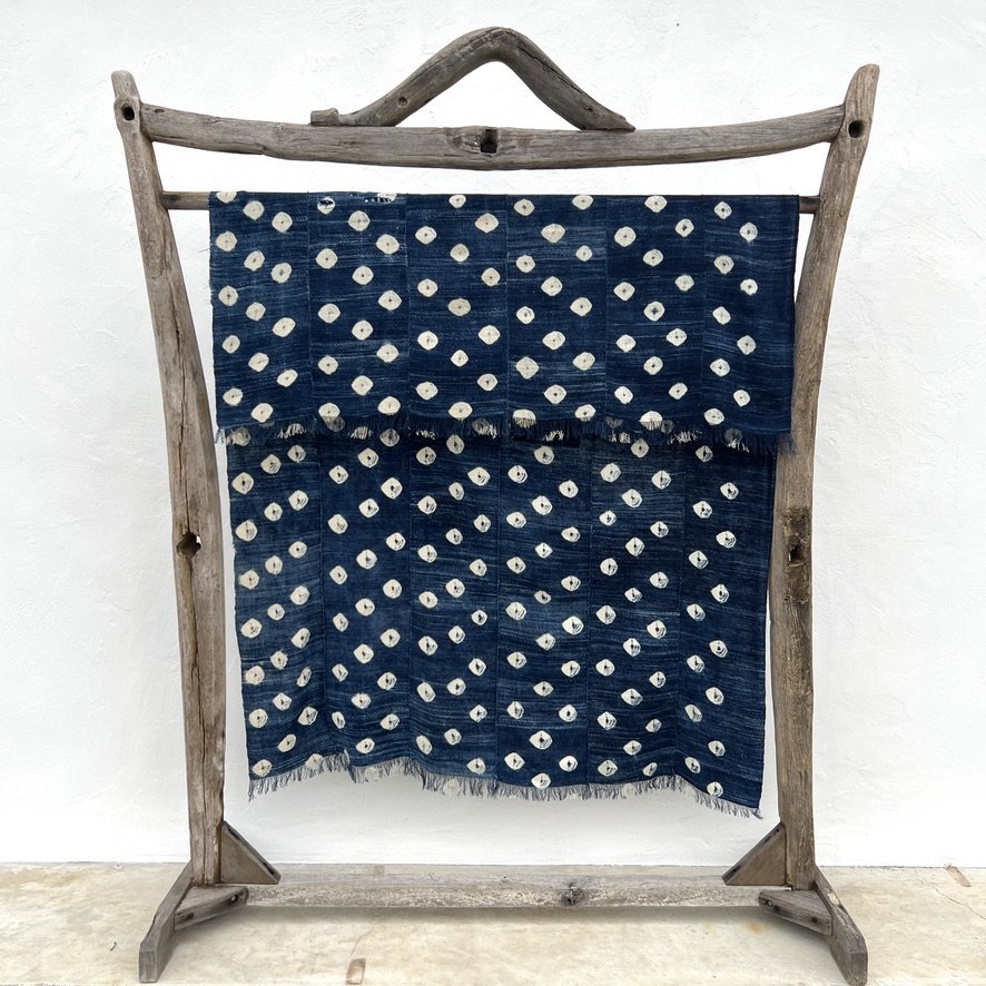 Indigo cloth dark blue cowrie shells visibly mended hanging