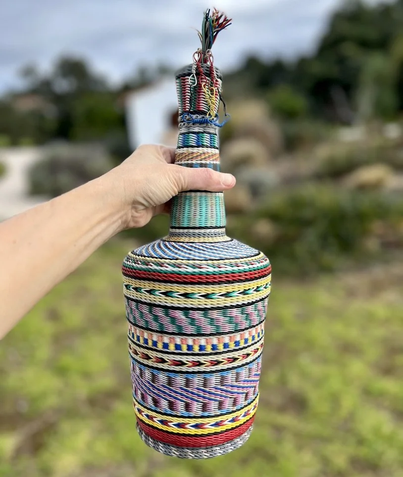 Wire-wrapped miner's bottle with hand