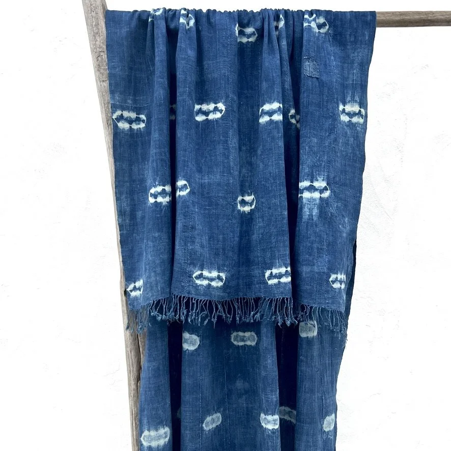 large indigo textile resist-dye with fringe hanging