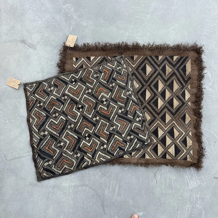 Square Kuba cloth from Congo with heart pattern in black, brown and beige with other Kuba textile