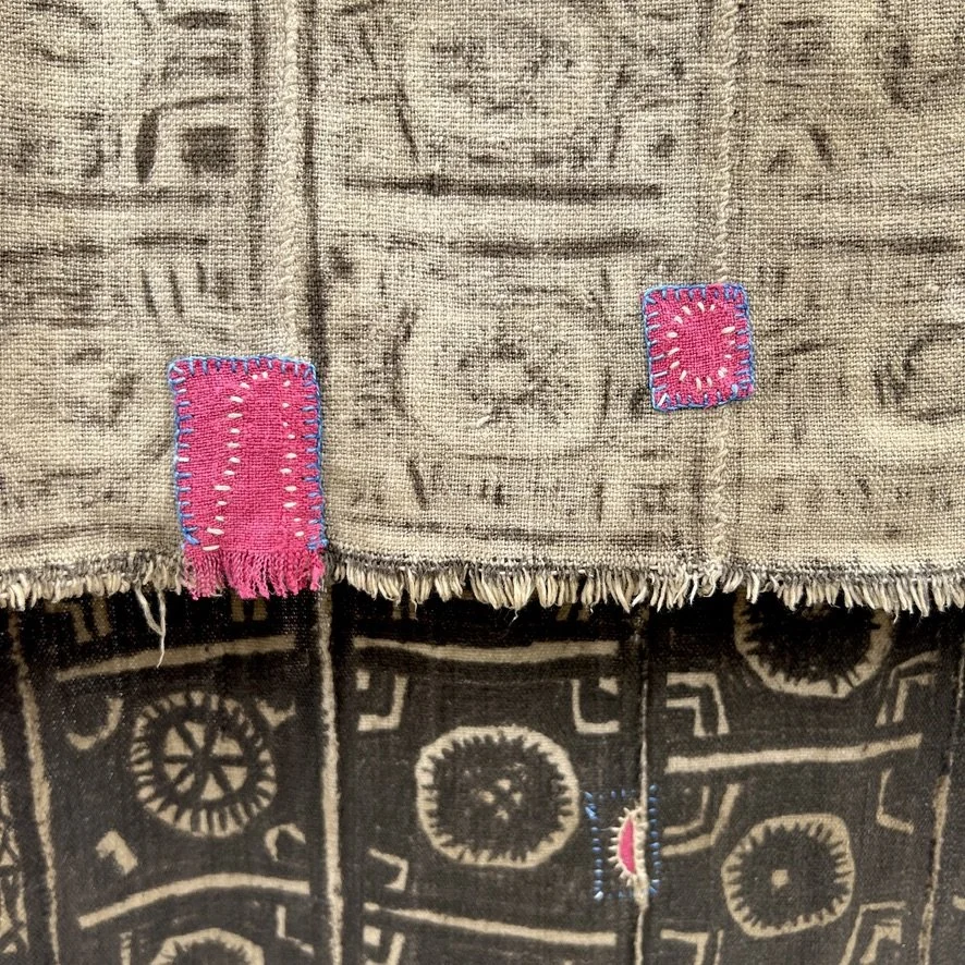 Visibly mended Mali mud cloth closeup back