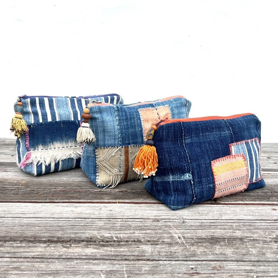 Indigo cloth pouch with orange patches with other pouches